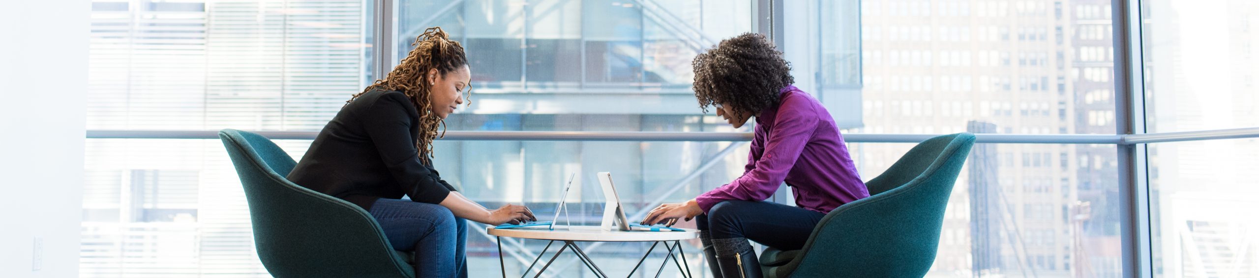 Two black women on laptops