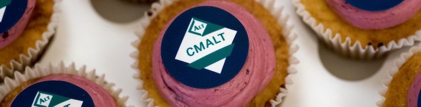 Round cupcakes with pink icing and the CMALT logo.
