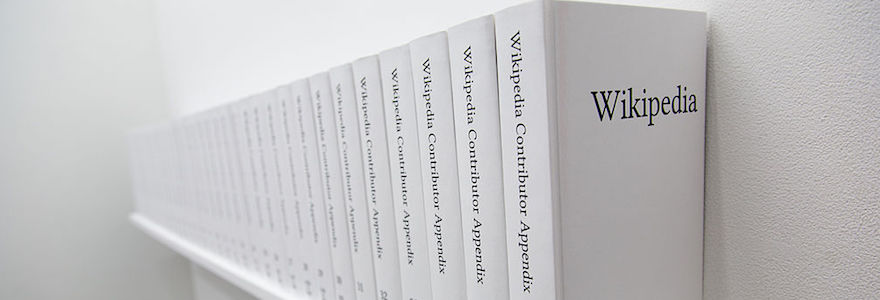 Shelf with a row of books title Wikipedia Contributors (multiple volumes)