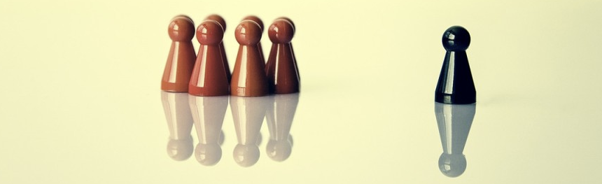 a group of red game pieces on the left and a solitary blue piece on the right.