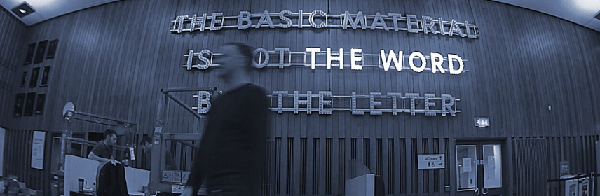 David Forsyth in front of his text based sculpturehe text