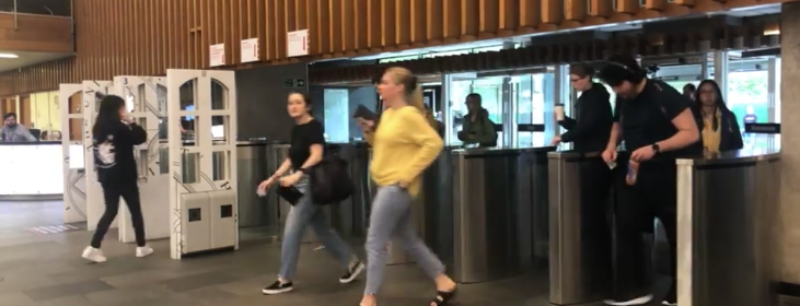 Students scanning their cards and walking into the library