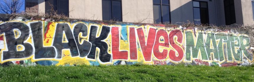 Black Lives Matter painted in colourful street art on a wall