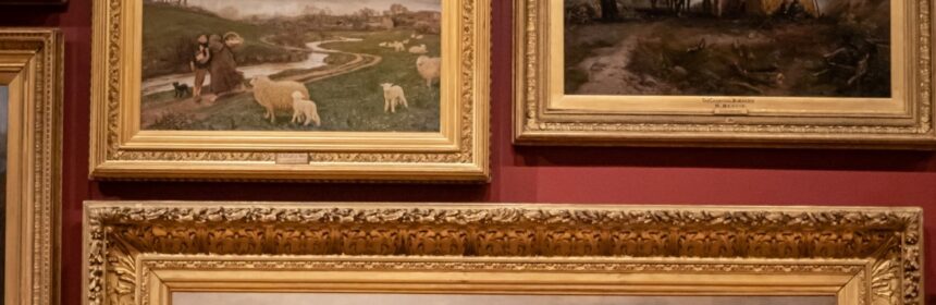 photo of an art gallery with several paintings of animals and nature that are ornate gold framed