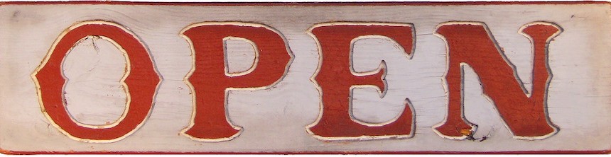 Weathered sign with red letters "OPEN"